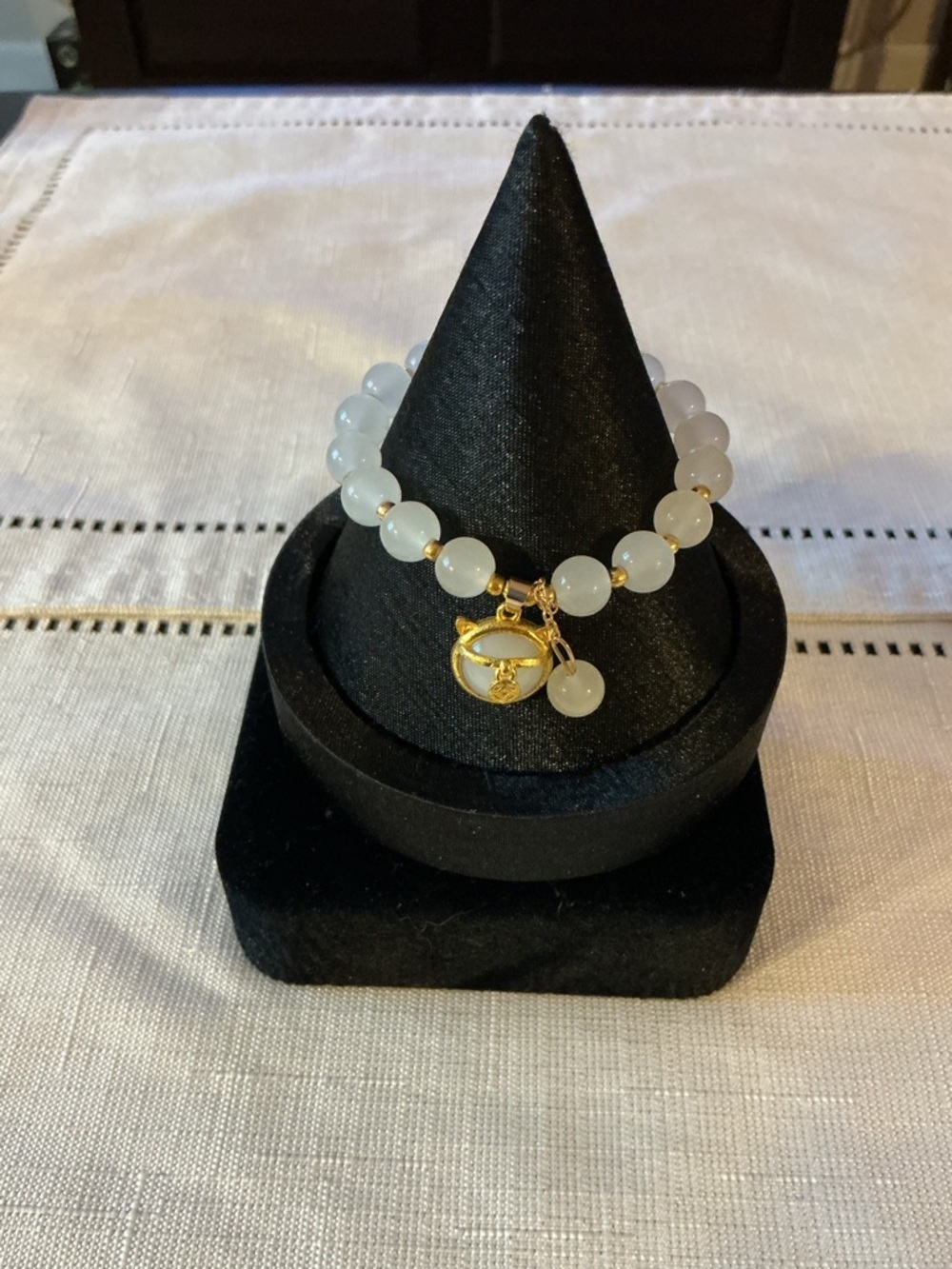 White Glass And Dangling Charm Gold Tone Stretch Bracelet